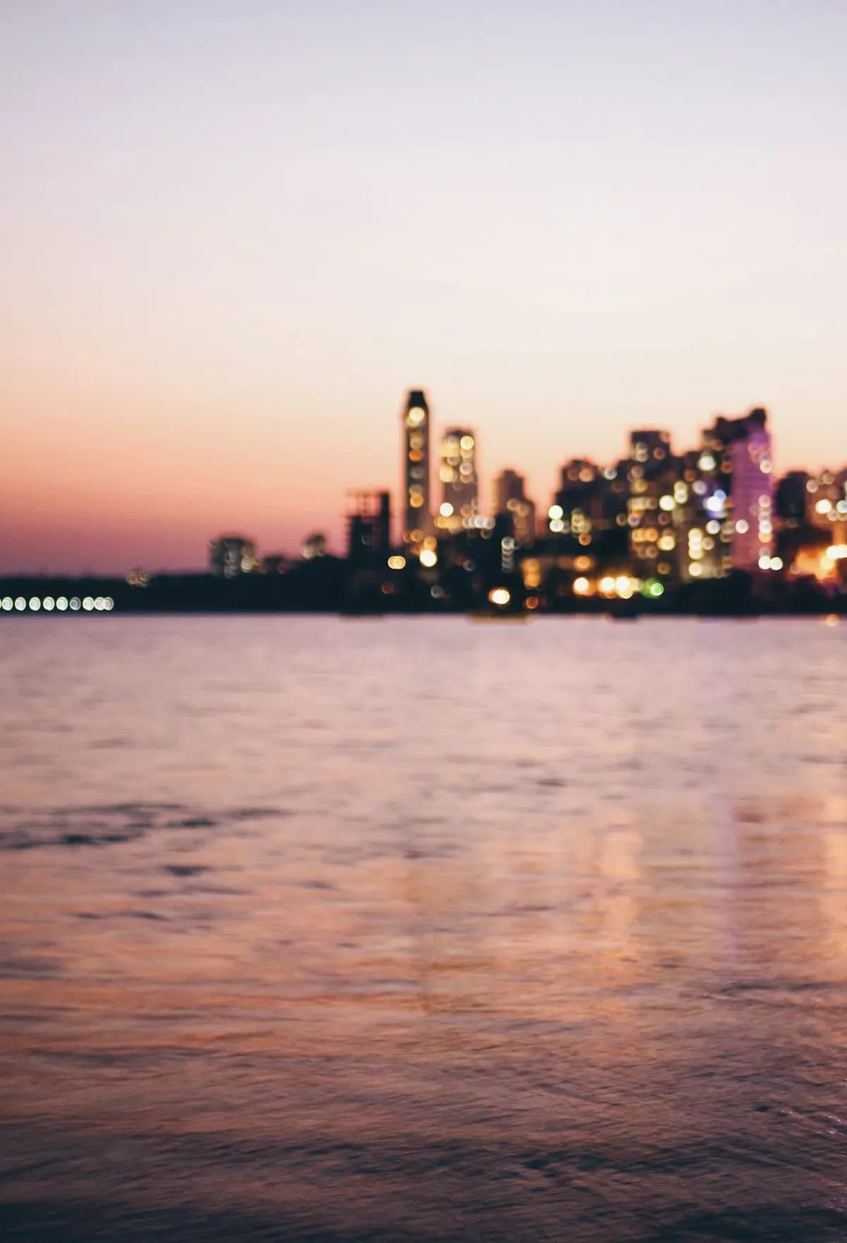 The Mumbai skyline at dusk, seen across the water from Marine Drive