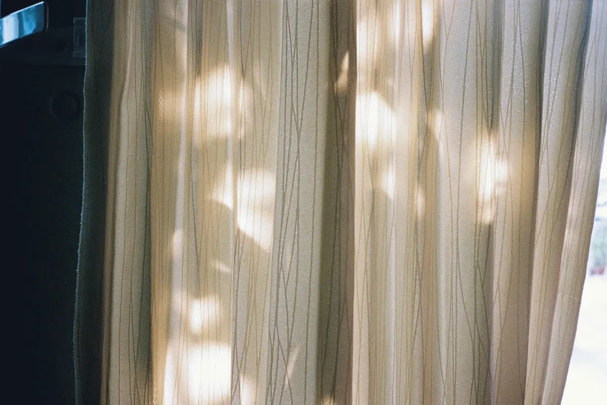 Morning light falling through sheer curtains